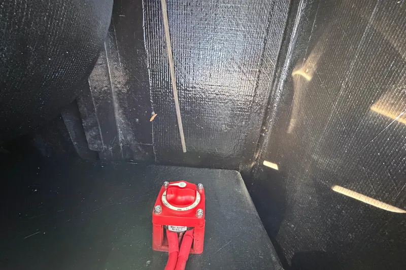 Slide: The Image of Red battery switch inside 2023 East Cape 18 EVO X boat compartment. - 75