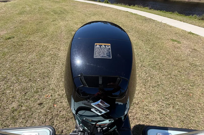 Slide: The Image of 2023 East Cape 18 EVO X outboard motor on grassy riverside. - 79