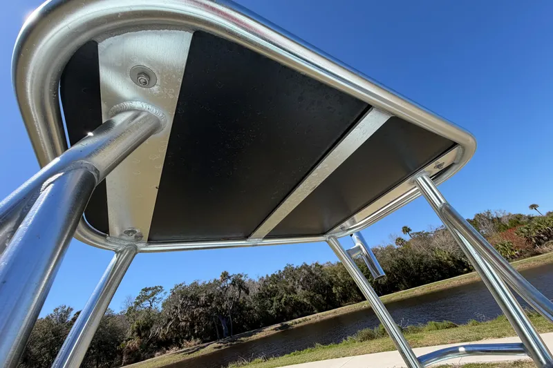 Slide: The Image of 2023 East Cape 18 EVO X boat T-top structure under clear blue sky. - 80