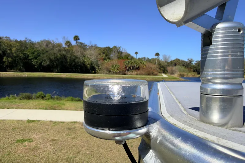 Slide: The Image of 2023 East Cape 18 EVO X boat detail with scenic river backdrop. - 85