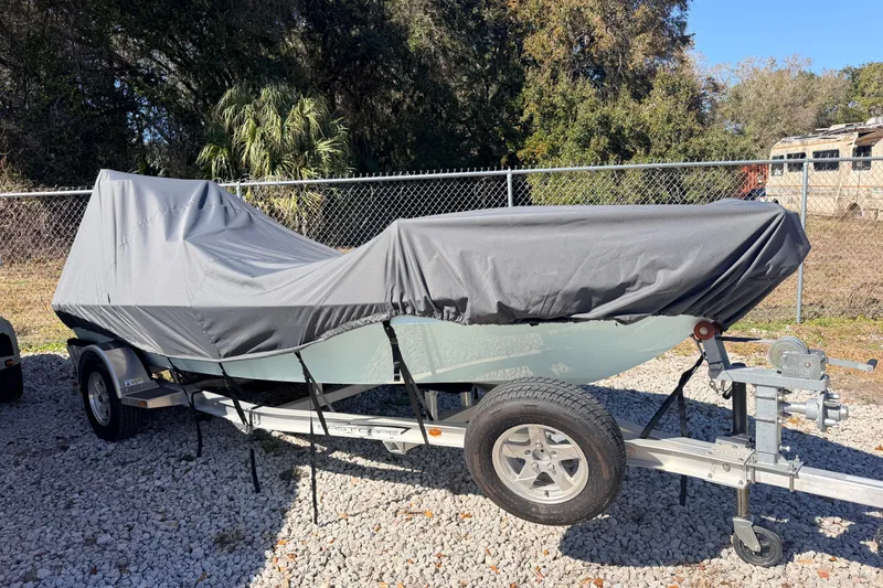 Slide: The Image of Covered 2023 East Cape 18 EVO X boat on trailer, parked outdoors. - 87