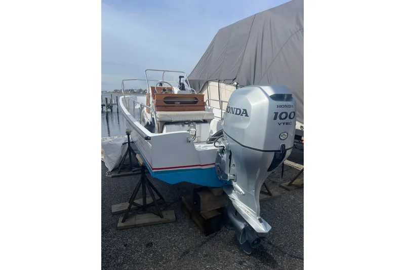 Slide: The Image of 1987 Boston Whaler 17 Montauk with Honda 100 VTEC outboard motor on display. - 1