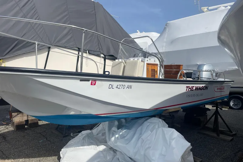 Slide: The Image of 1987 Boston Whaler 17 Montauk boat on stands, labeled "The Wagon," in storage. - 2