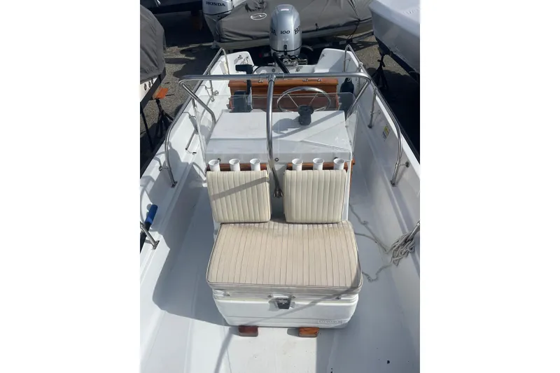 Slide: The Image of 1987 Boston Whaler 17 Montauk boat interior with seating and steering console. - 4