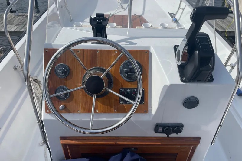Slide: The Image of Steering console of a 1987 Boston Whaler 17 Montauk boat with gauges and controls. - 6