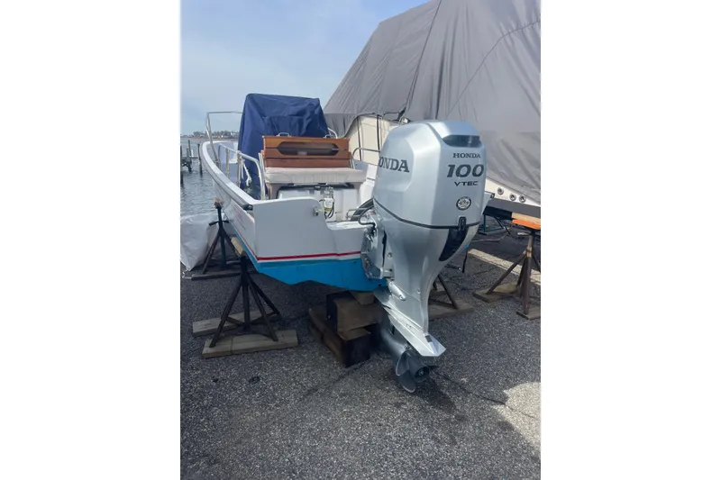 Slide: The Image of 1987 Boston Whaler 17 Montauk with Honda 100 VTEC outboard motor on stands. - 7