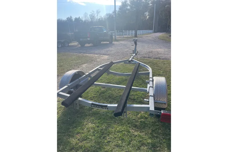 Slide: The Image of Boat trailer for 1987 Boston Whaler 17 Montauk on grassy area. - 9