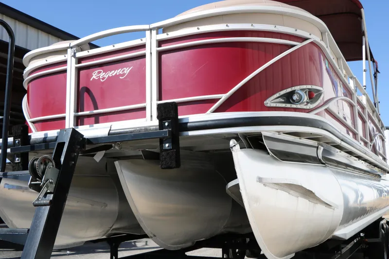 Slide: The Image of 2014 Regency Party Barge 254 XP3 pontoon boat on trailer, red and white design. - 11