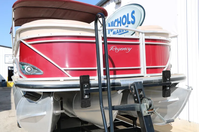 Slide: The Image of 2014 Regency Party Barge 254 XP3 pontoon boat in vibrant red, docked at marina. - 12