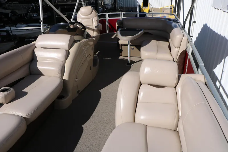 Slide: The Image of 2014 Regency Party Barge 254 XP3 interior with beige seating and steering console. - 24