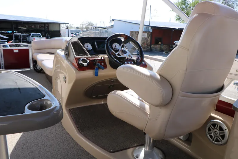 Slide: The Image of 2014 Regency Party Barge 254 XP3 interior with steering wheel and seating area. - 34