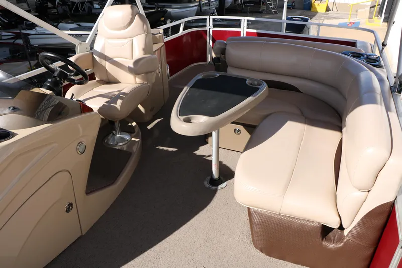 Slide: The Image of 2014 Regency Party Barge 254 XP3 interior with beige seating and steering console. - 49