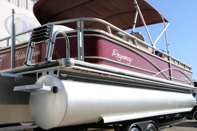Slide: The Image of 2014 Regency Party Barge 254 XP3 pontoon boat with maroon exterior and ladder. - 5