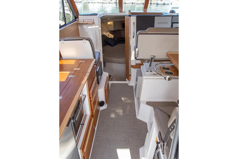 Slide: The Image of Manufacturer Provided Image: Interior of 2023 Cutwater C-32 C boat, featuring modern kitchen and seating area. - 16