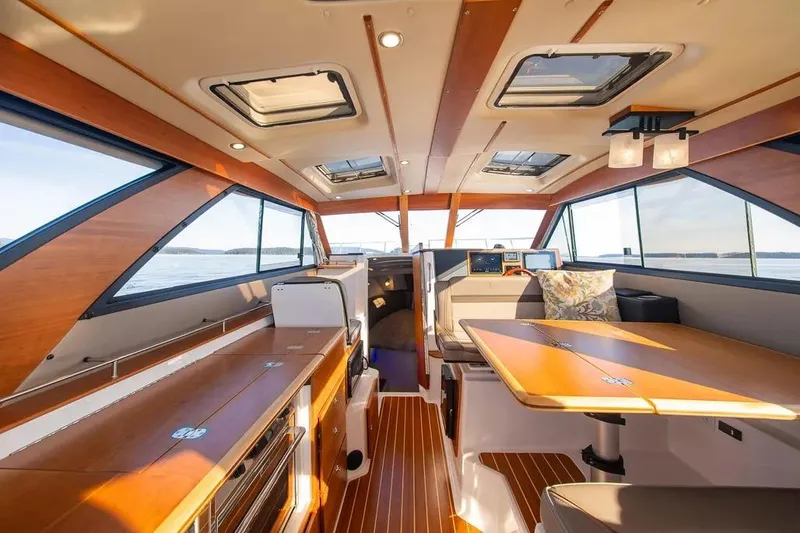 Slide: The Image of Interior of 2023 Cutwater C-32 Coupe boat, featuring elegant wood finishes and modern design. - 21
