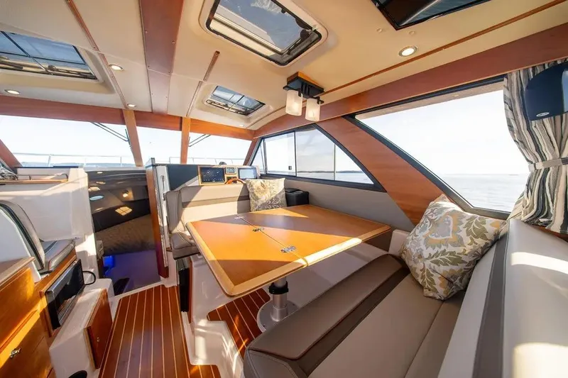 Slide: The Image of 2023 Cutwater C-32 Coupe interior with elegant wood finish and spacious seating area. - 22