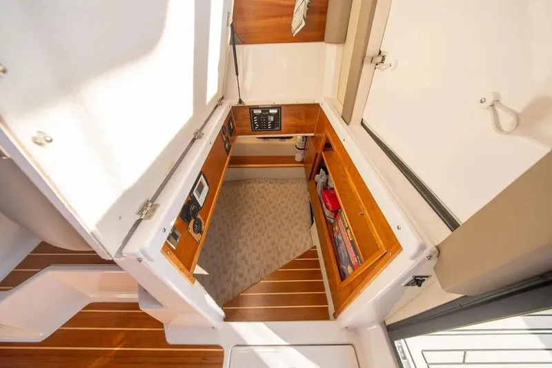 Slide: The Image of 2023 Cutwater C-32 Coupe interior cabin with wood accents and control panel. - 25