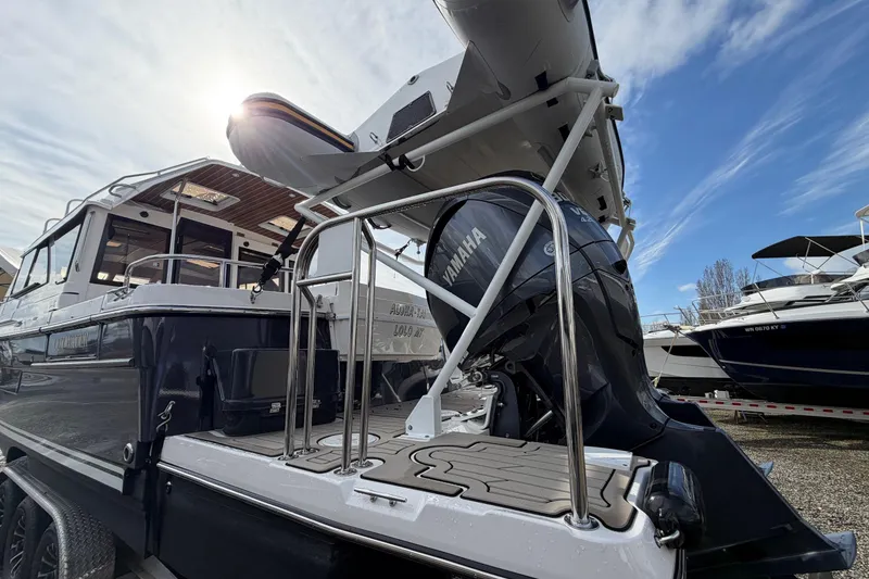 Slide: The Image of 2023 Cutwater C-32 Coupe boat with Yamaha outboard motor under a clear sky. - 4