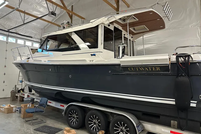 Slide: The Image of 2023 Cutwater C-32 Coupe boat on trailer in a garage setting. - 6