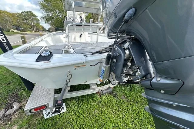 Slide: The Image of 2021 Avid 21 Mag boat on trailer with outboard motor, parked on grass. - 6