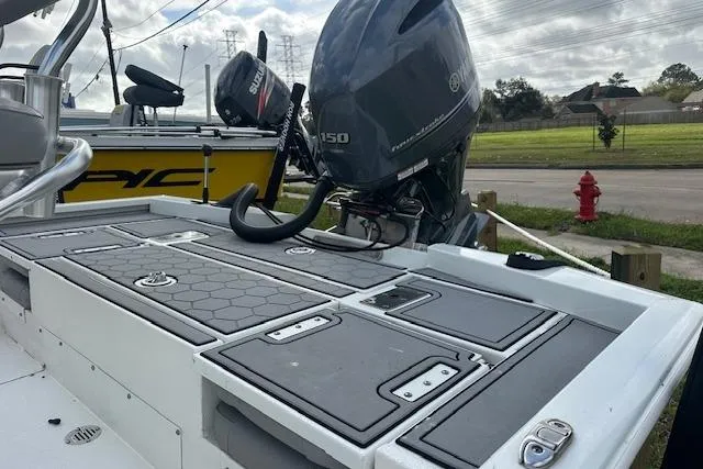 Slide: The Image of Avid 21 Mag 2021 boat with Yamaha 150 engine, docked outdoors. - 7