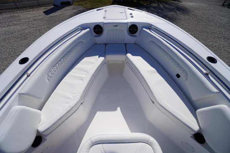 Slide: The Image of 2026 Tidewater 232 CC Adventure boat interior with white cushioned seating. - 10