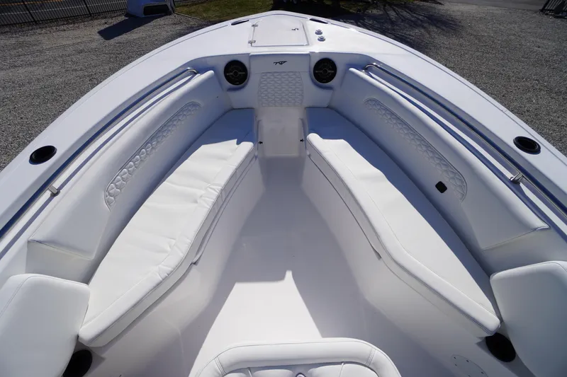 Slide: The Image of 2026 Tidewater 232 CC Adventure boat interior with white cushioned seating. - 11