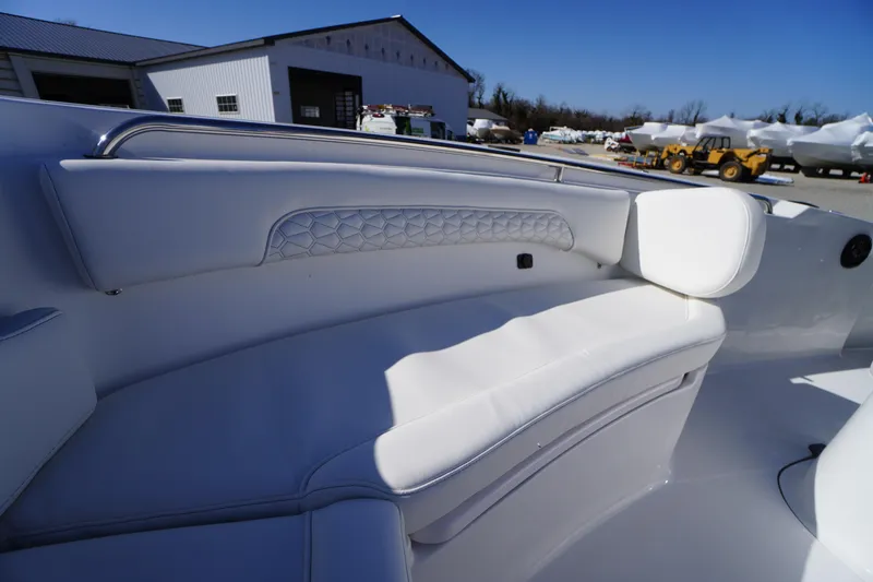Slide: The Image of 2026 Tidewater 232 CC Adventure boat interior with white cushioned seating. - 12