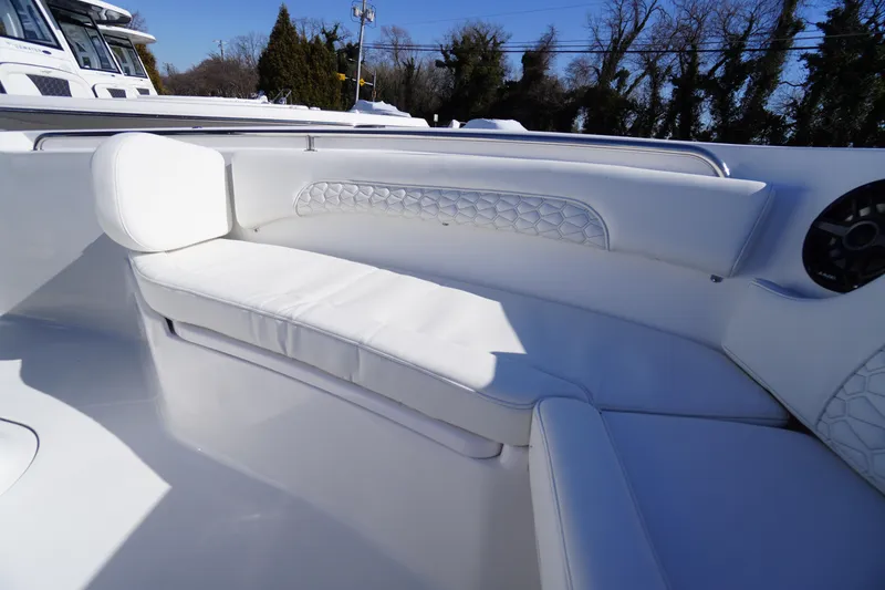 Slide: The Image of Luxurious seating on 2026 Tidewater 232 CC Adventure boat, featuring elegant white upholstery. - 13