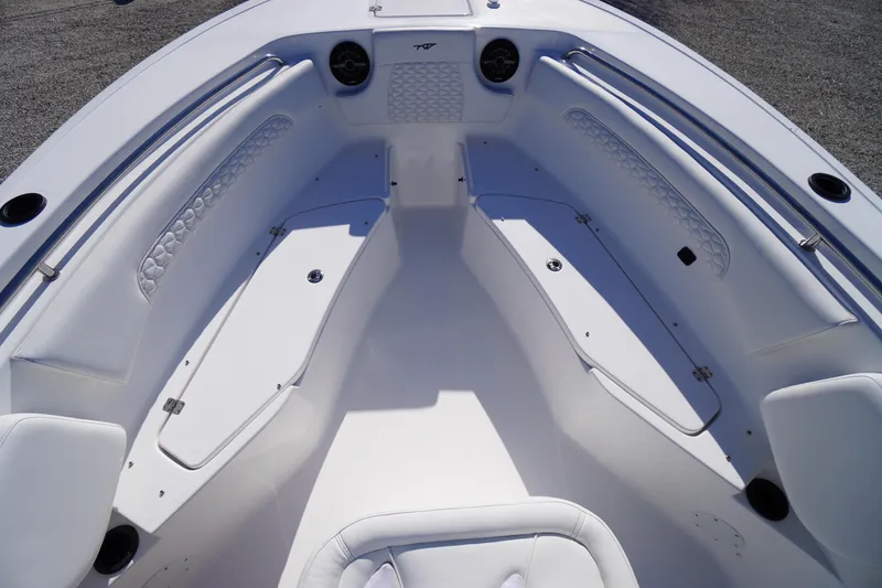 Slide: The Image of 2026 Tidewater 232 CC Adventure boat interior with cushioned seating and storage compartments. - 14