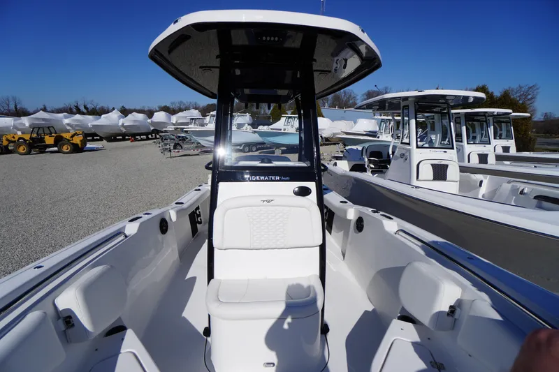 Slide: The Image of 2026 Tidewater 232 CC Adventure boat displayed in a marina under clear blue skies. - 16