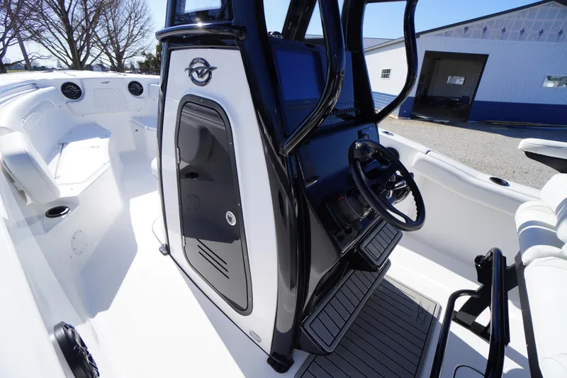 Slide: The Image of 2026 Tidewater 232 CC Adventure boat interior with steering console and seating. - 19