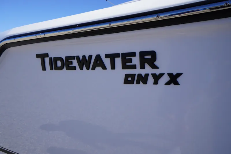 Slide: The Image of 2026 Tidewater 232 CC Adventure boat with Onyx branding on the side. - 2