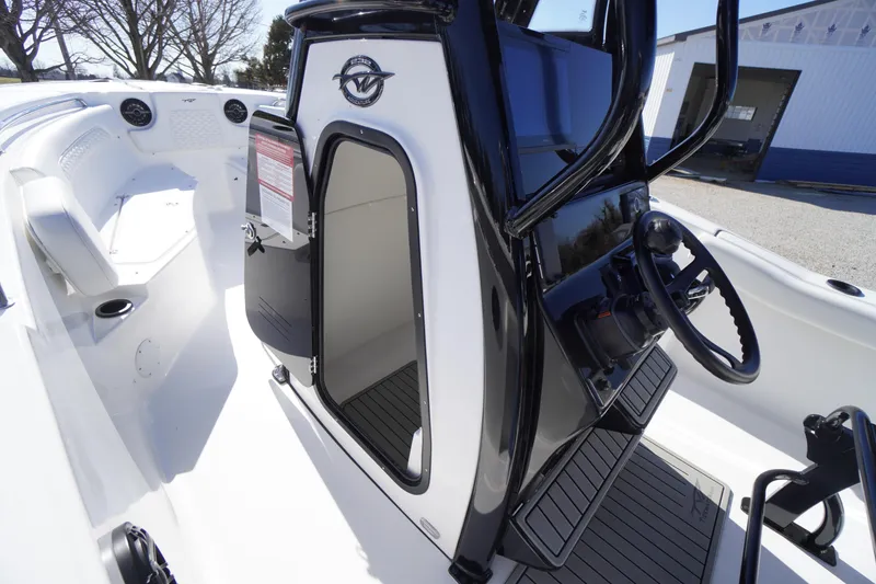 Slide: The Image of 2026 Tidewater 232 CC Adventure boat interior with helm and seating area. - 20