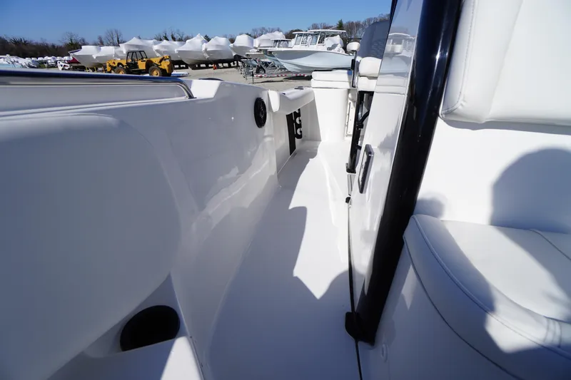 Slide: The Image of 2026 Tidewater 232 CC Adventure boat interior, showcasing sleek white seating and modern design. - 22