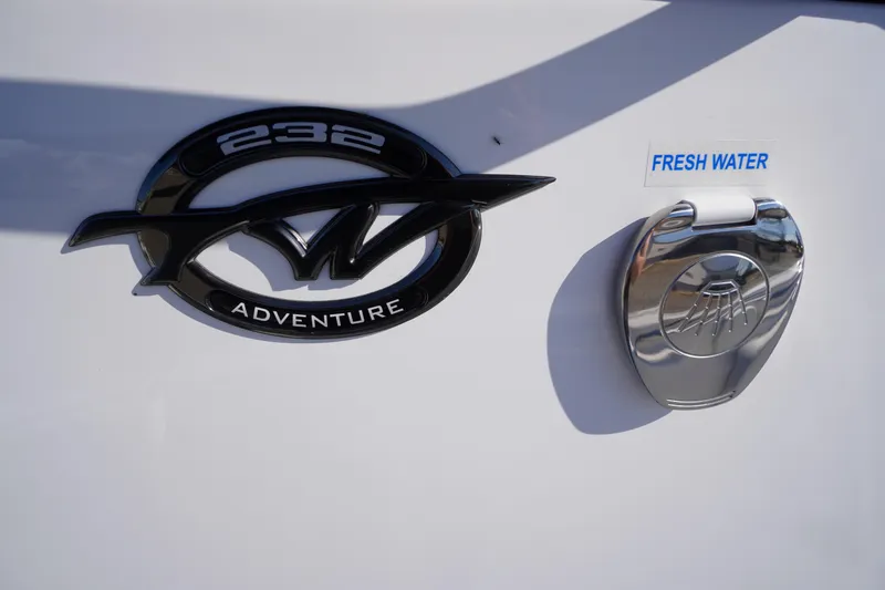 Slide: The Image of 2026 Tidewater 232 CC Adventure boat emblem and fresh water access. - 24