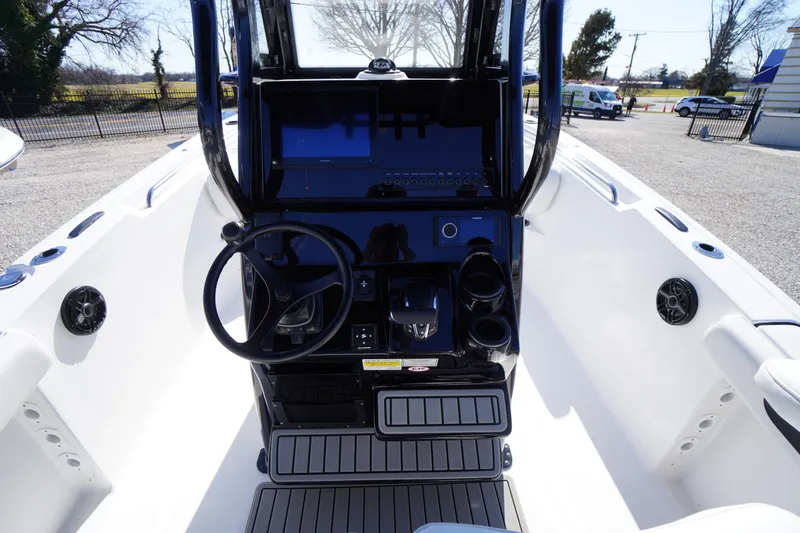 Slide: The Image of 2026 Tidewater 232 CC Adventure boat cockpit with steering wheel and control panel. - 26