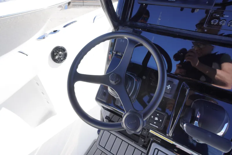 Slide: The Image of Steering wheel of 2026 Tidewater 232 CC Adventure boat, featuring modern controls and sleek design. - 27