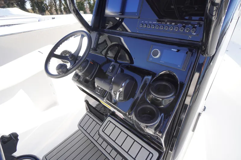Slide: The Image of 2026 Tidewater 232 CC Adventure boat console with steering wheel and controls. - 29