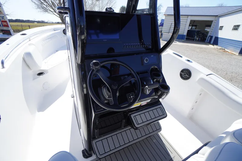 Slide: The Image of 2026 Tidewater 232 CC Adventure boat cockpit with steering wheel and control panel. - 30