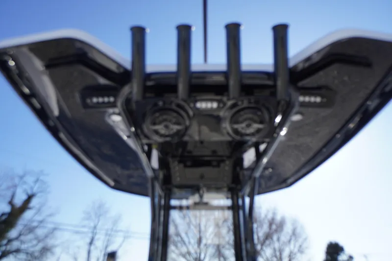 Slide: The Image of 2026 Tidewater 232 CC Adventure boat's T-top with rod holders and speakers, viewed from below. - 33