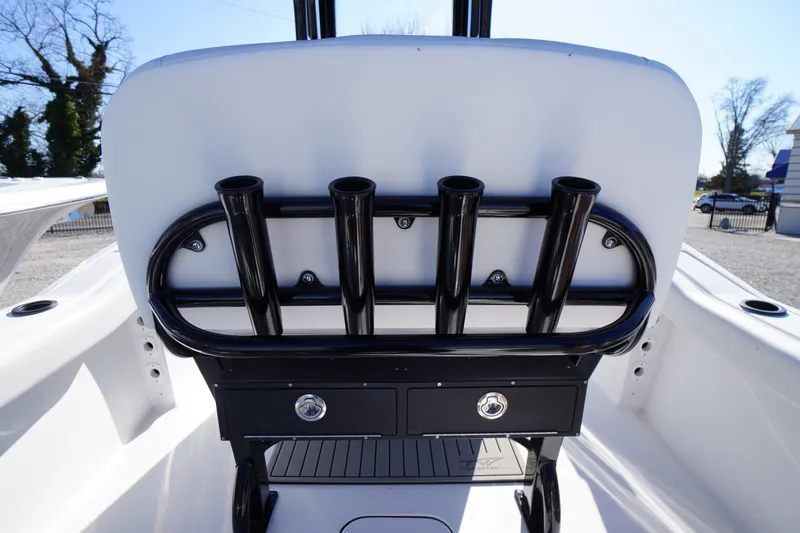 Slide: The Image of 2026 Tidewater 232 CC Adventure boat interior with rod holders and storage drawers. - 40
