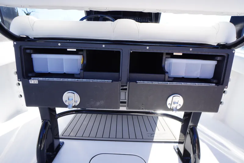 Slide: The Image of 2026 Tidewater 232 CC Adventure boat storage compartments with secure locks and organized bins. - 41