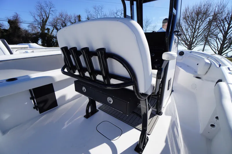 Slide: The Image of 2026 Tidewater 232 CC Adventure boat interior with rod holders and seating. - 42