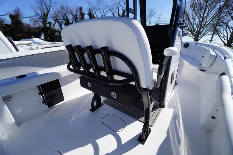 Slide: The Image of 2026 Tidewater 232 CC Adventure boat interior with seating and rod holders. - 43