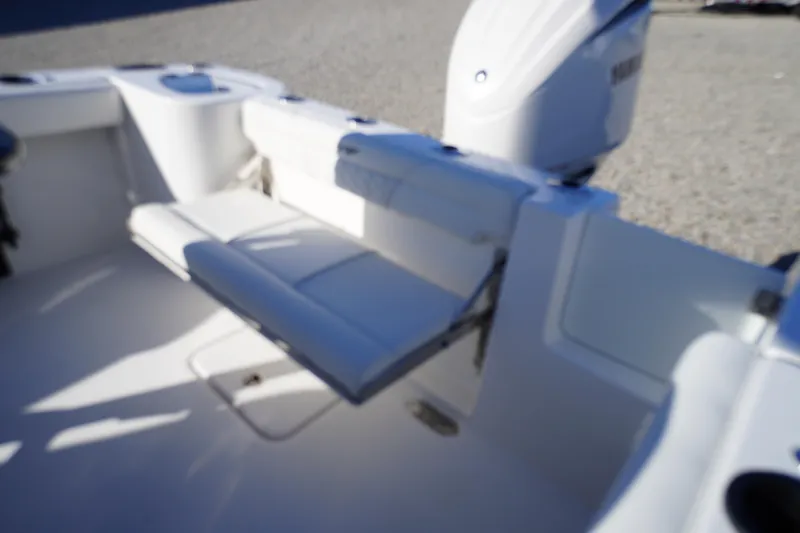Slide: The Image of 2026 Tidewater 232 CC Adventure boat interior with seating and motor. - 47