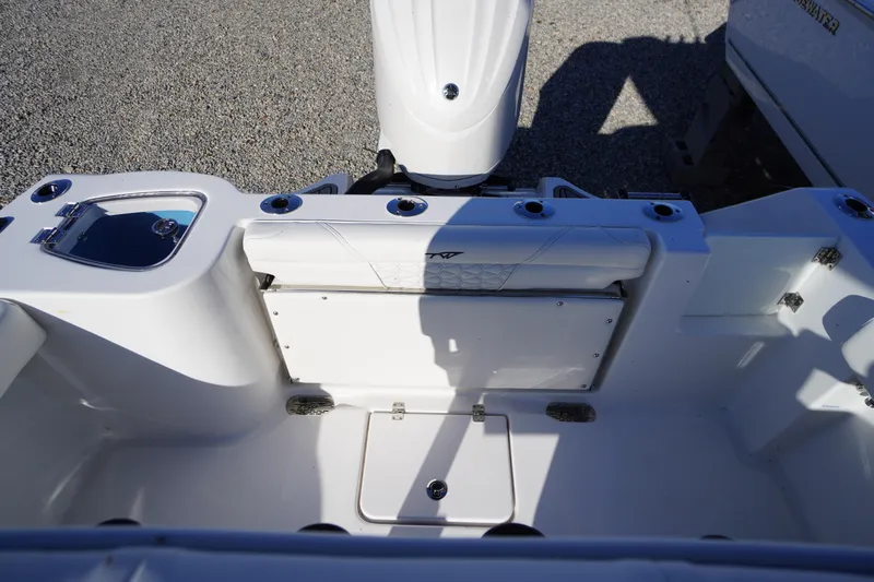 Slide: The Image of 2026 Tidewater 232 CC Adventure boat interior with seating and storage compartments. - 49