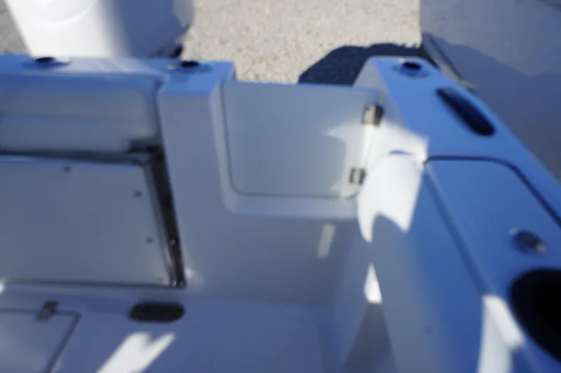 Slide: The Image of 2026 Tidewater 232 CC Adventure boat interior with open hatch and seating area. - 53