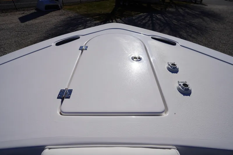Slide: The Image of Bow deck of 2026 Tidewater 232 CC Adventure boat, featuring storage hatch and fittings. - 6