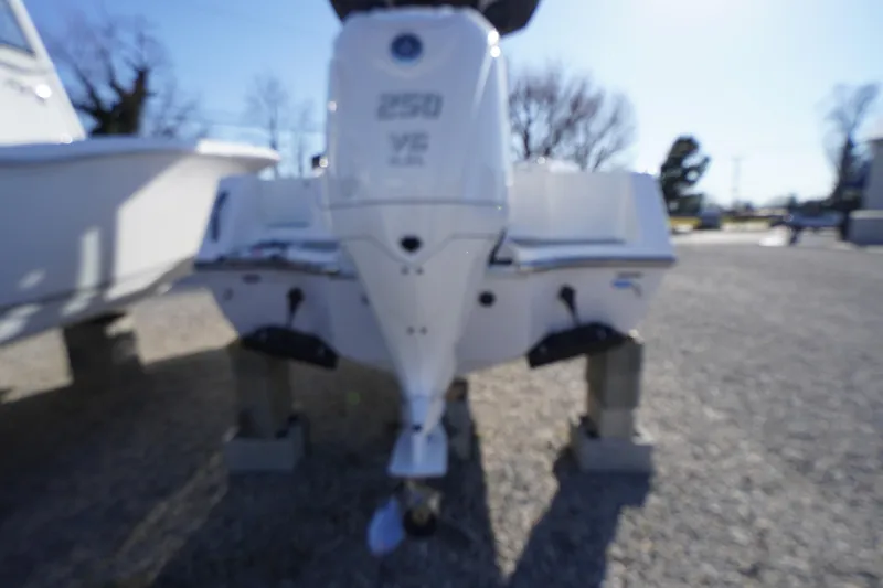 Slide: The Image of 2026 Tidewater 232 CC Adventure boat with powerful outboard motor, displayed outdoors. - 61